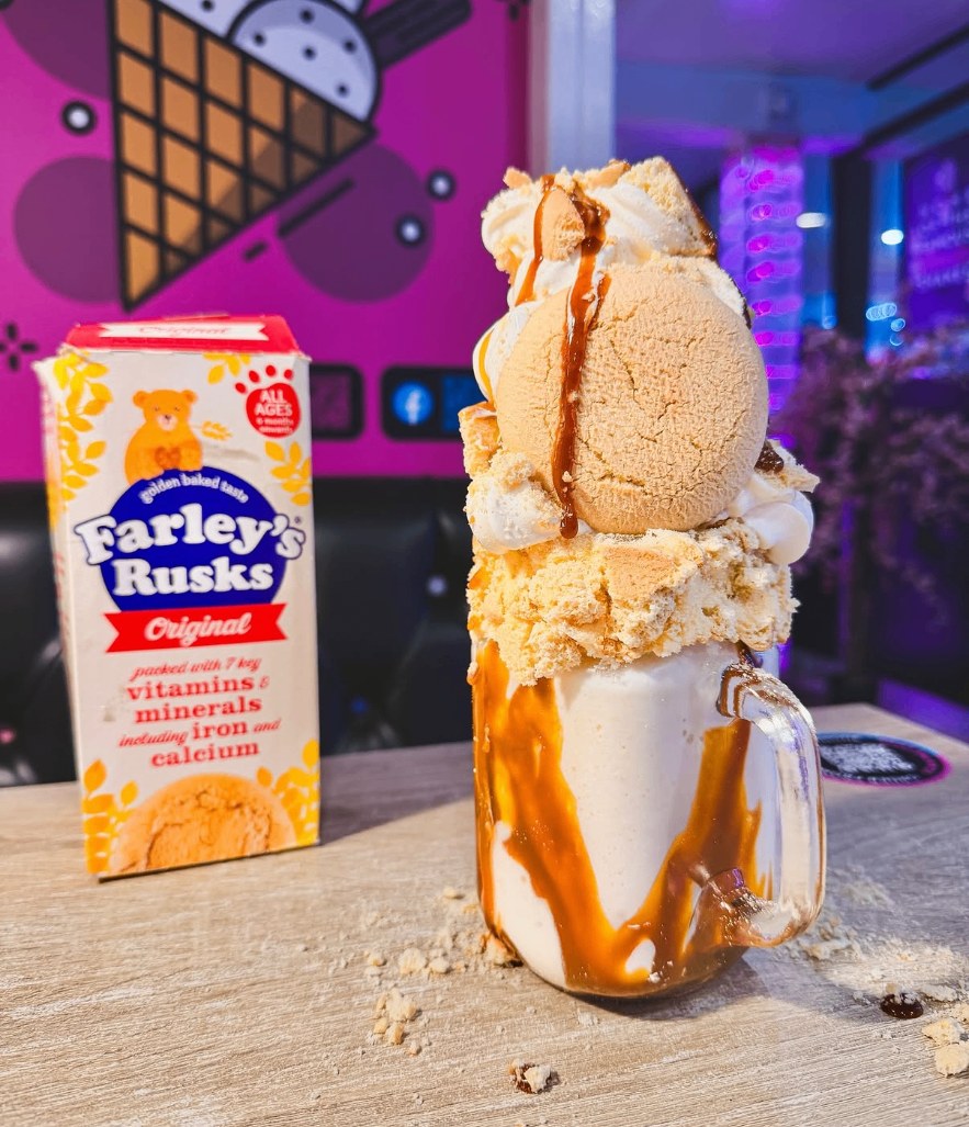 A rusks milkshake piled with ice cream and caramel sauce