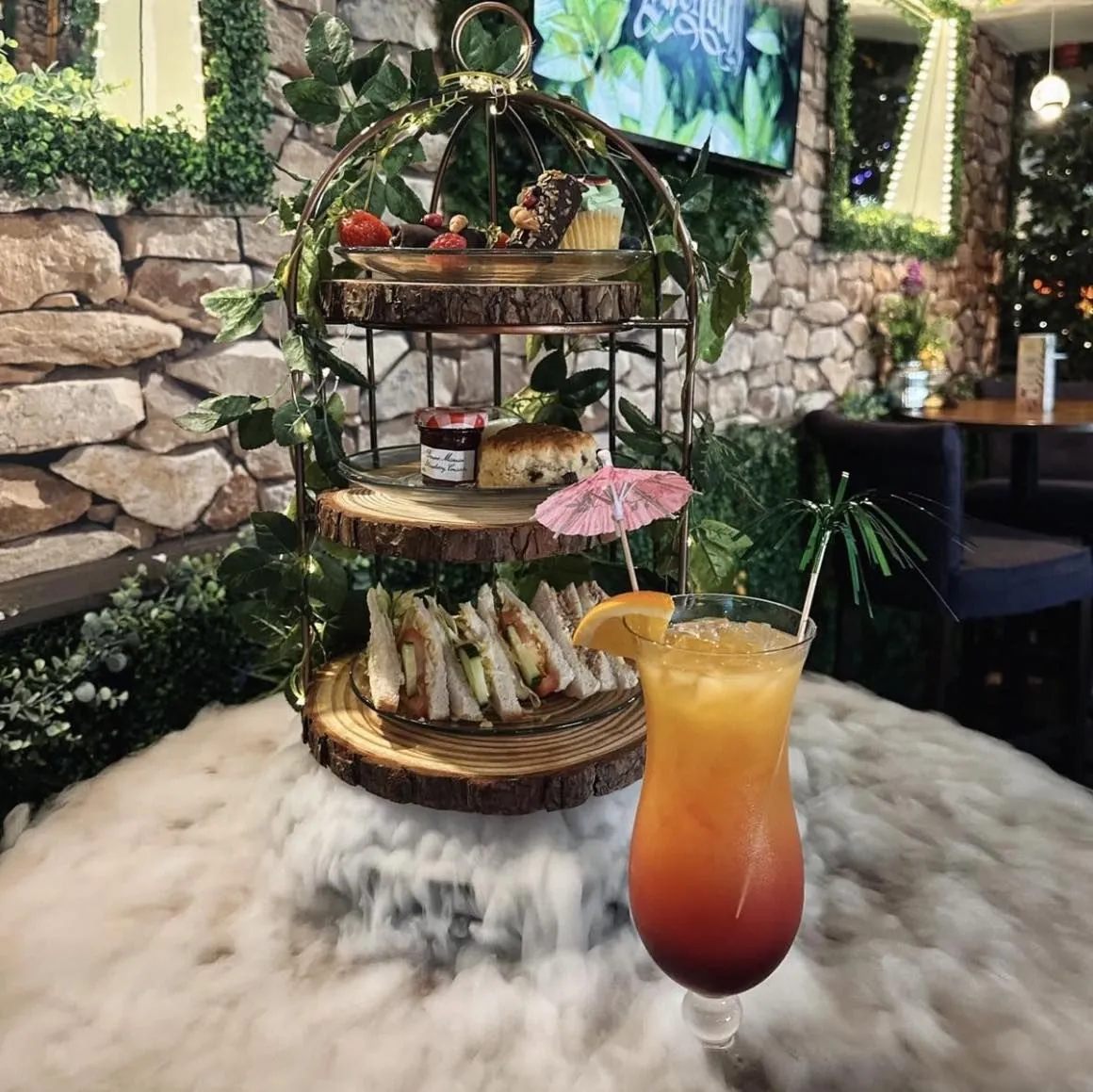 Afternoon tea stand and cocktail on a marble table