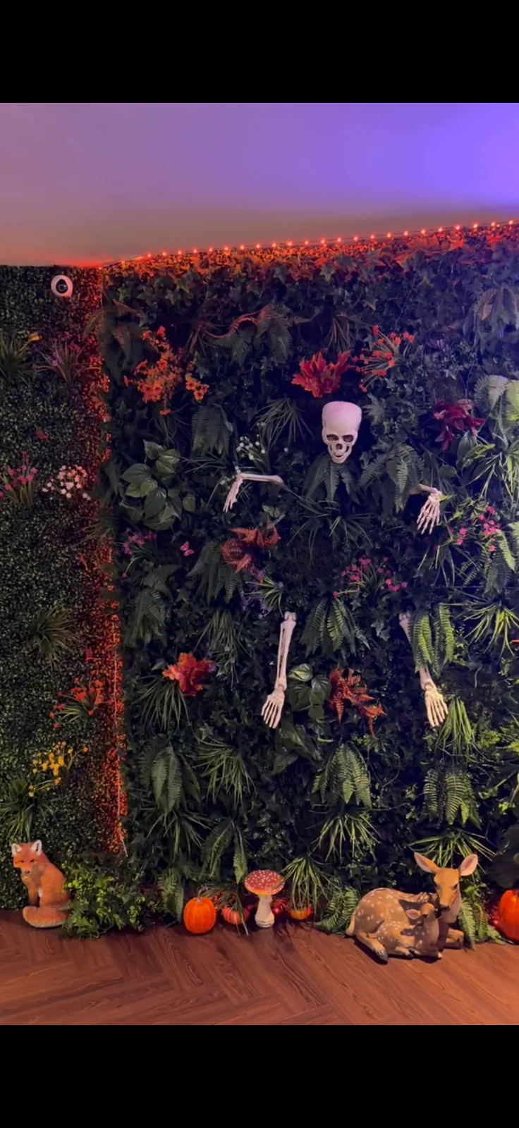 Halloween flower wall with skeleton and pumpkins at Enchant