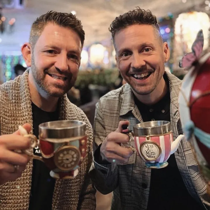 Two guests toasting with themed mugs